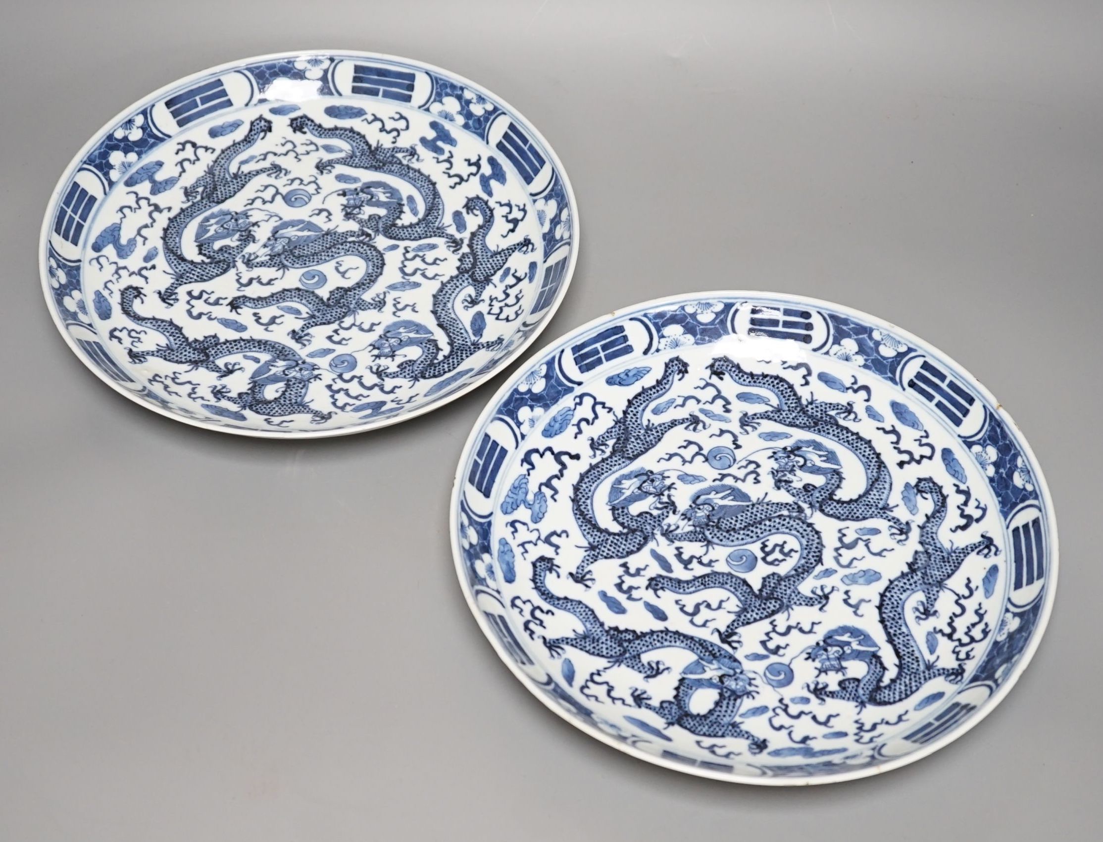 A pair of Chinese blue and white ‘dragon’ dishes, Qing dynasty, 27cm diameter